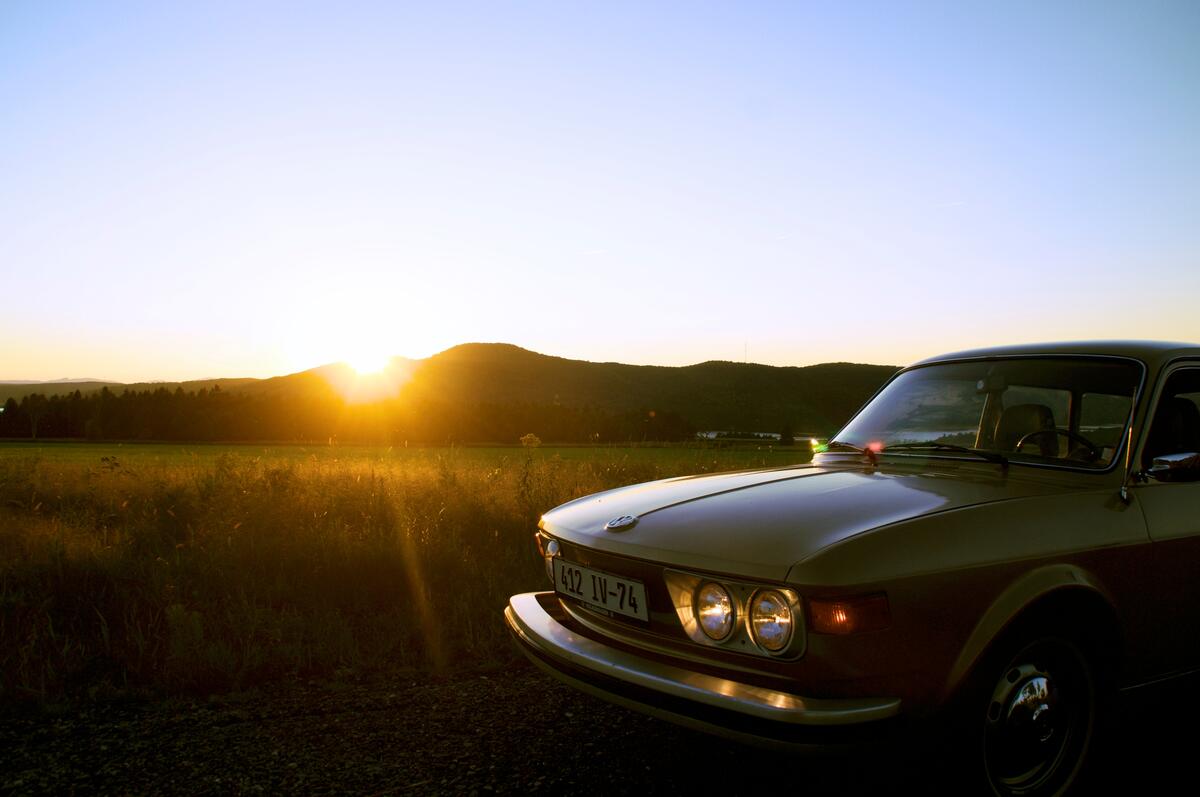 A vintage car at sunset