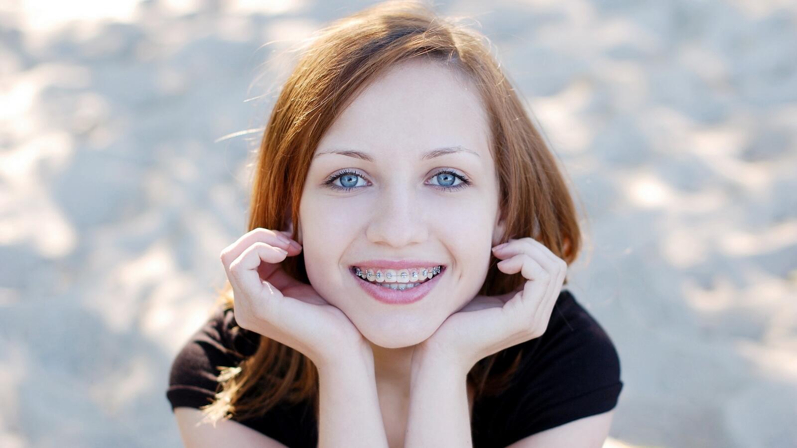 Free photo Redheaded girl smiling in braces