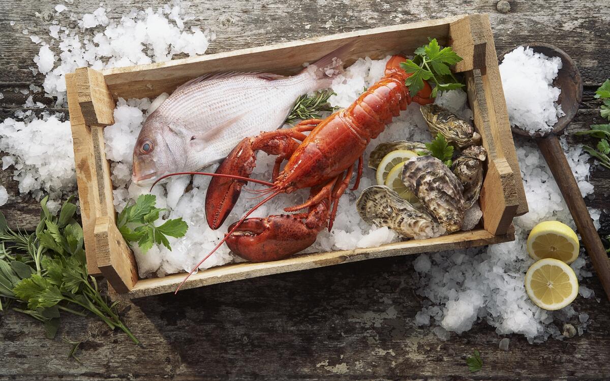 Red salted lobster in a wooden box.
