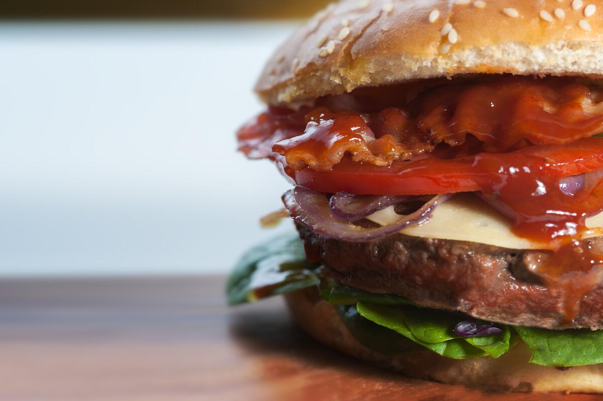 A close-up of a hamburger with ketchup.