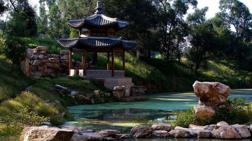 Japanese style gazebo next to the pond