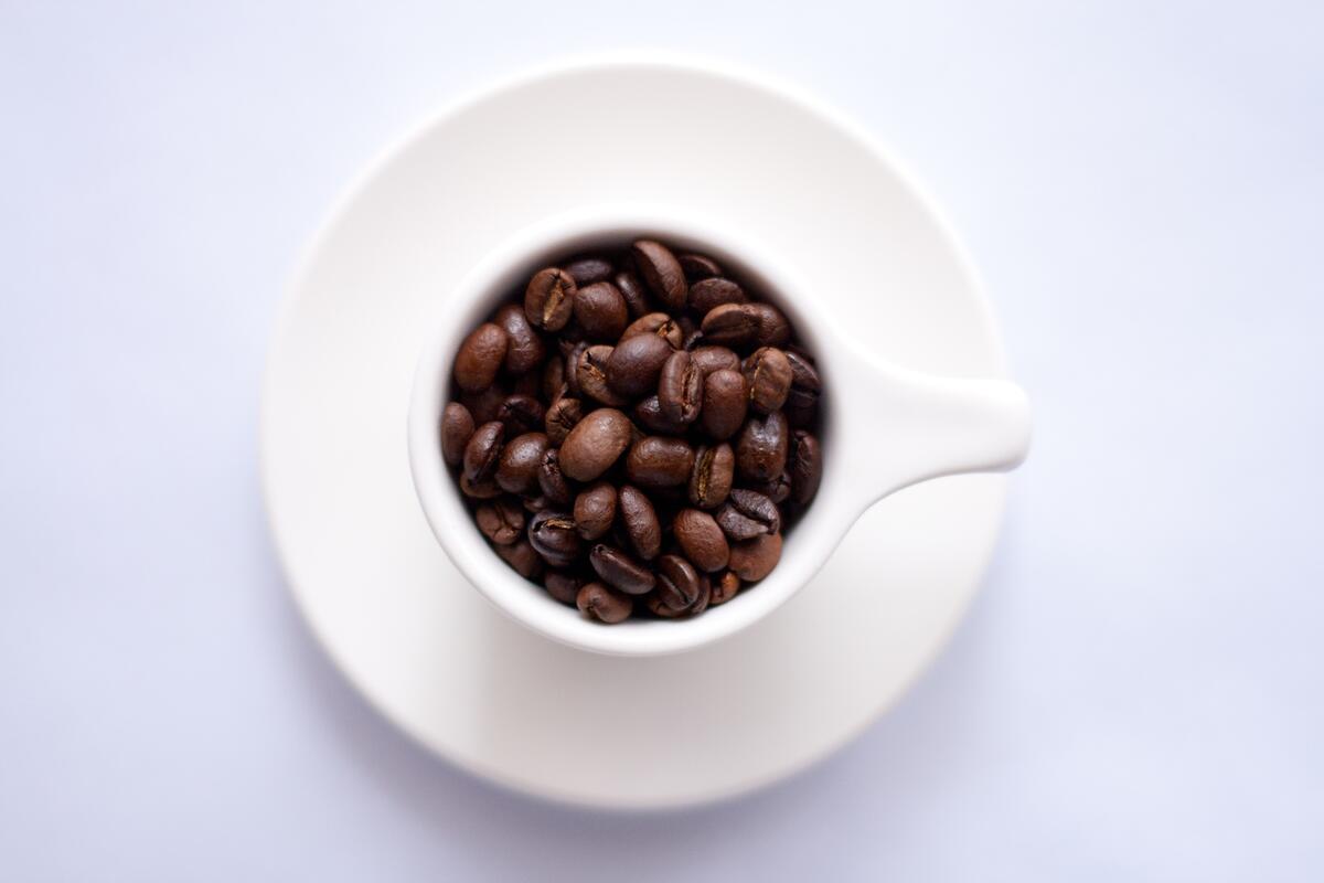 A cup filled with coffee beans.