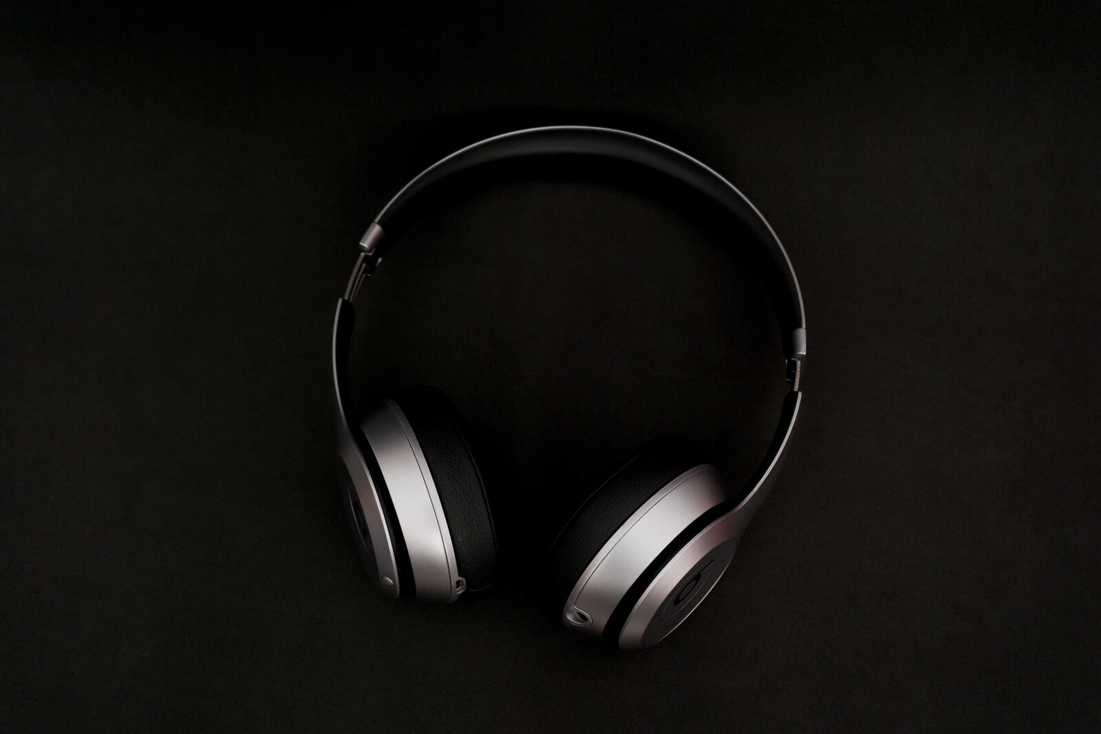Free photo Metal headphones on a black background