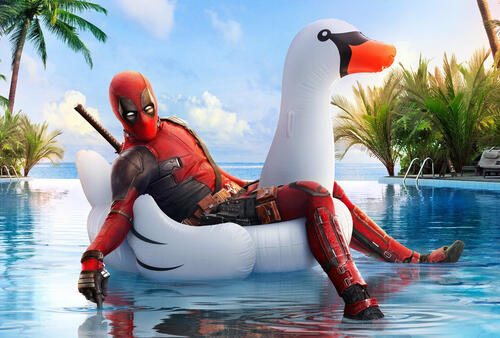 DeadPool 2 rides an inflatable swan in the pool