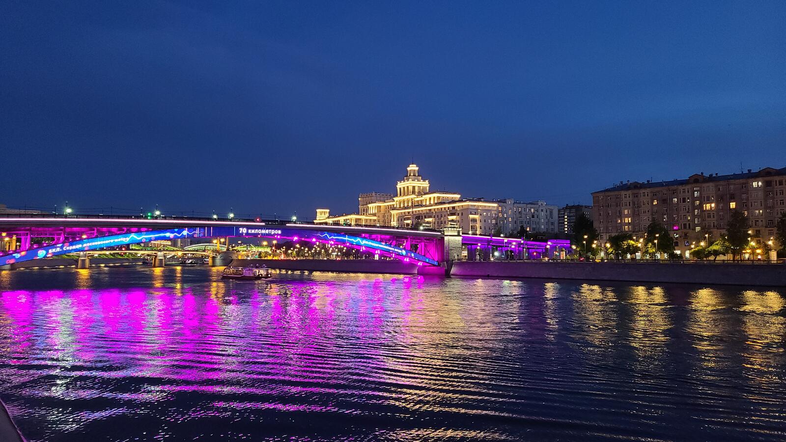 Free photo A night bridge with multicolored neon lighting