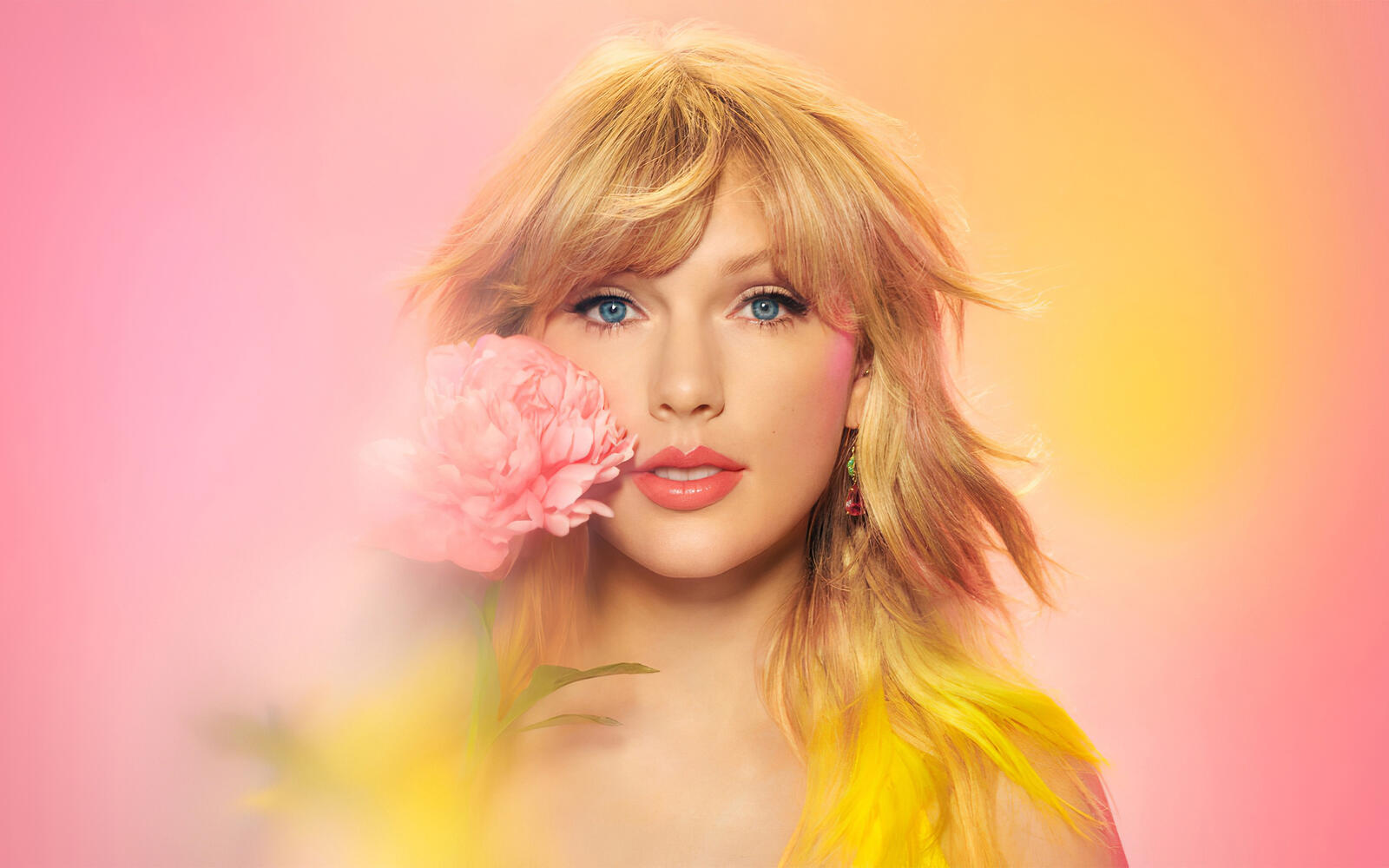 Free photo Taylor Swift with a pink flower.