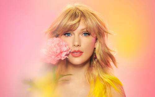 Taylor Swift with a pink flower.