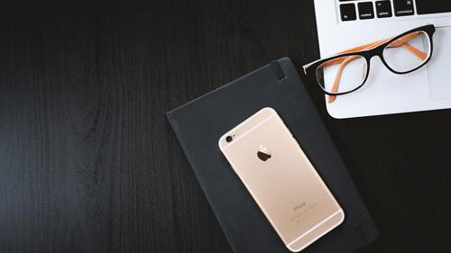 The Iphone is on a stylish black table