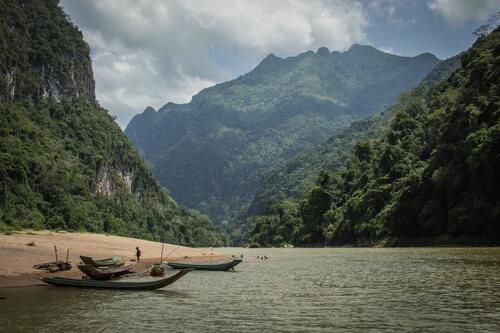 Old wooden boats on a lake in the mountains
