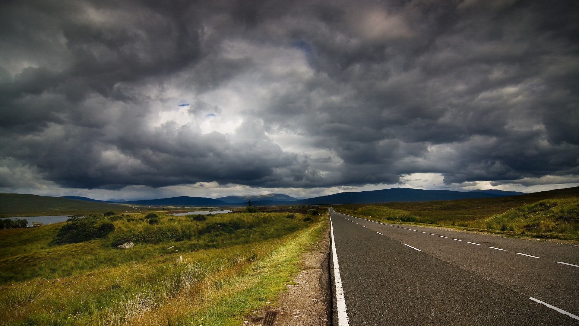 An asphalt road under thick clouds