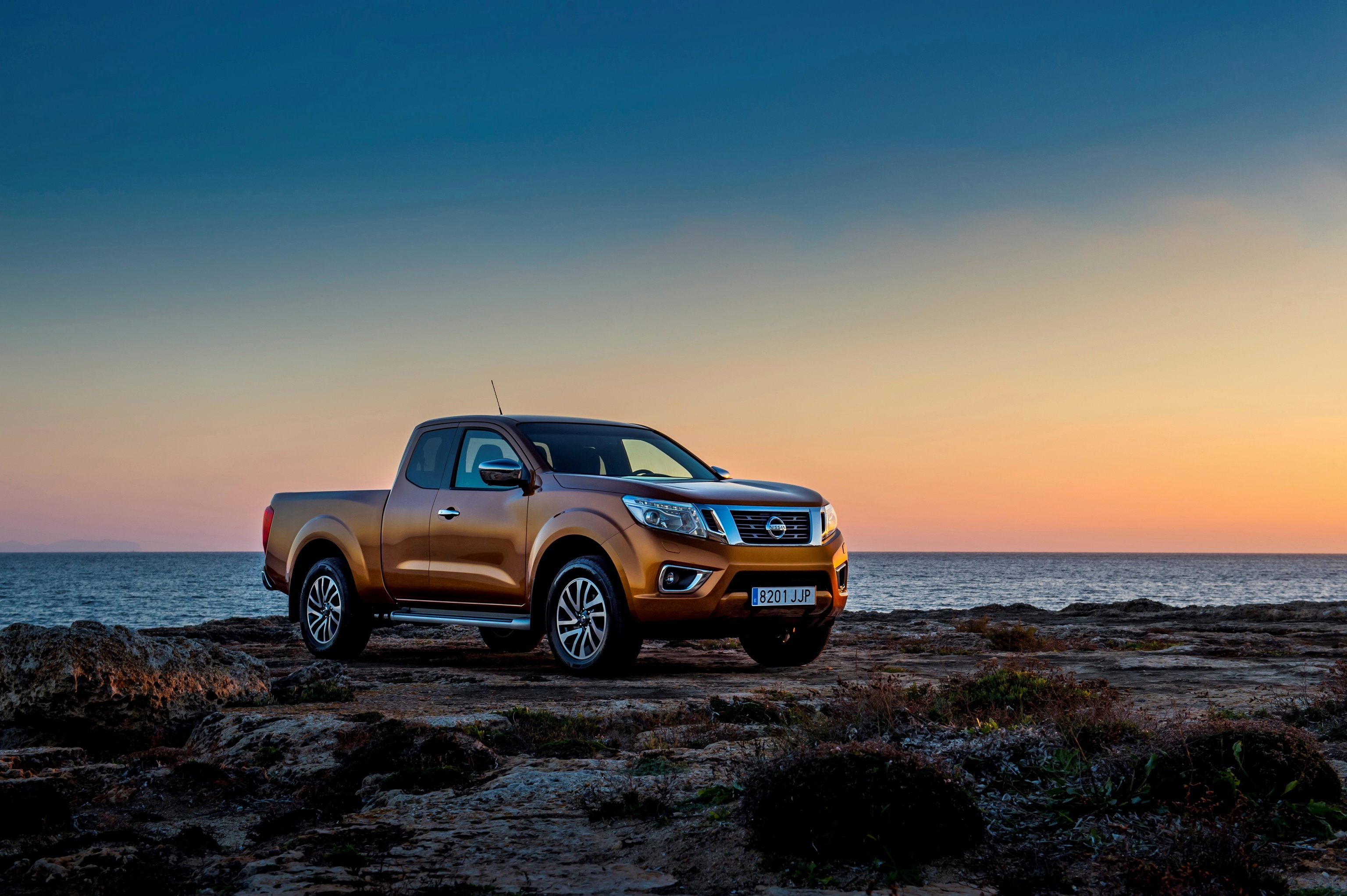 Nissan Navara stands on the beach during sunset