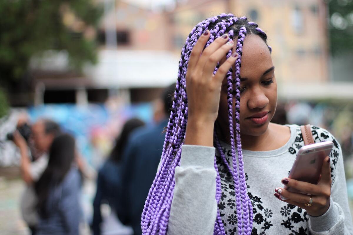 Beautiful dark-skinned girl with purple pigtails