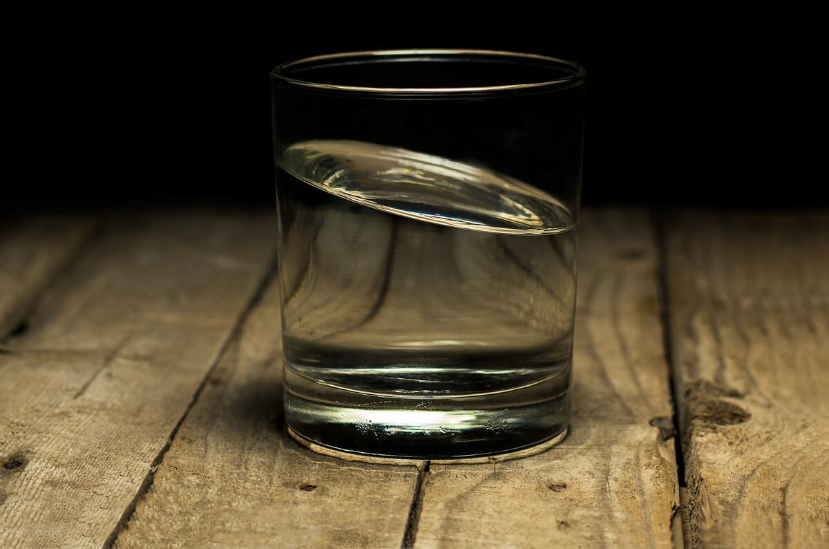 Transparent glass of water on a wooden table