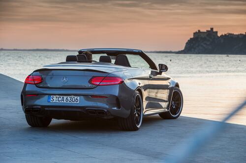 Mercedes AMG C63 S Cabriolet stands by the sea rear view