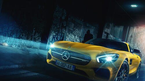 Yellow Mercedes AMG with lights on