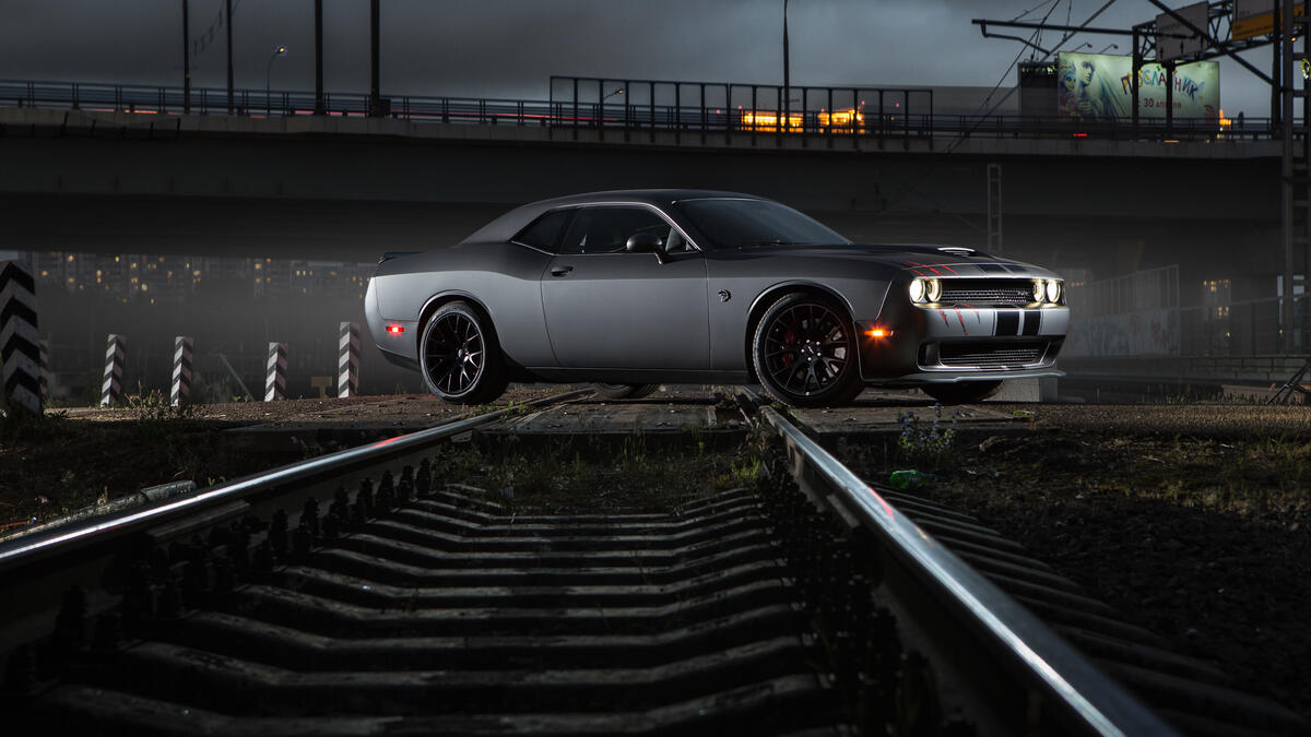 Dodge Challenger is parked on the railroad tracks