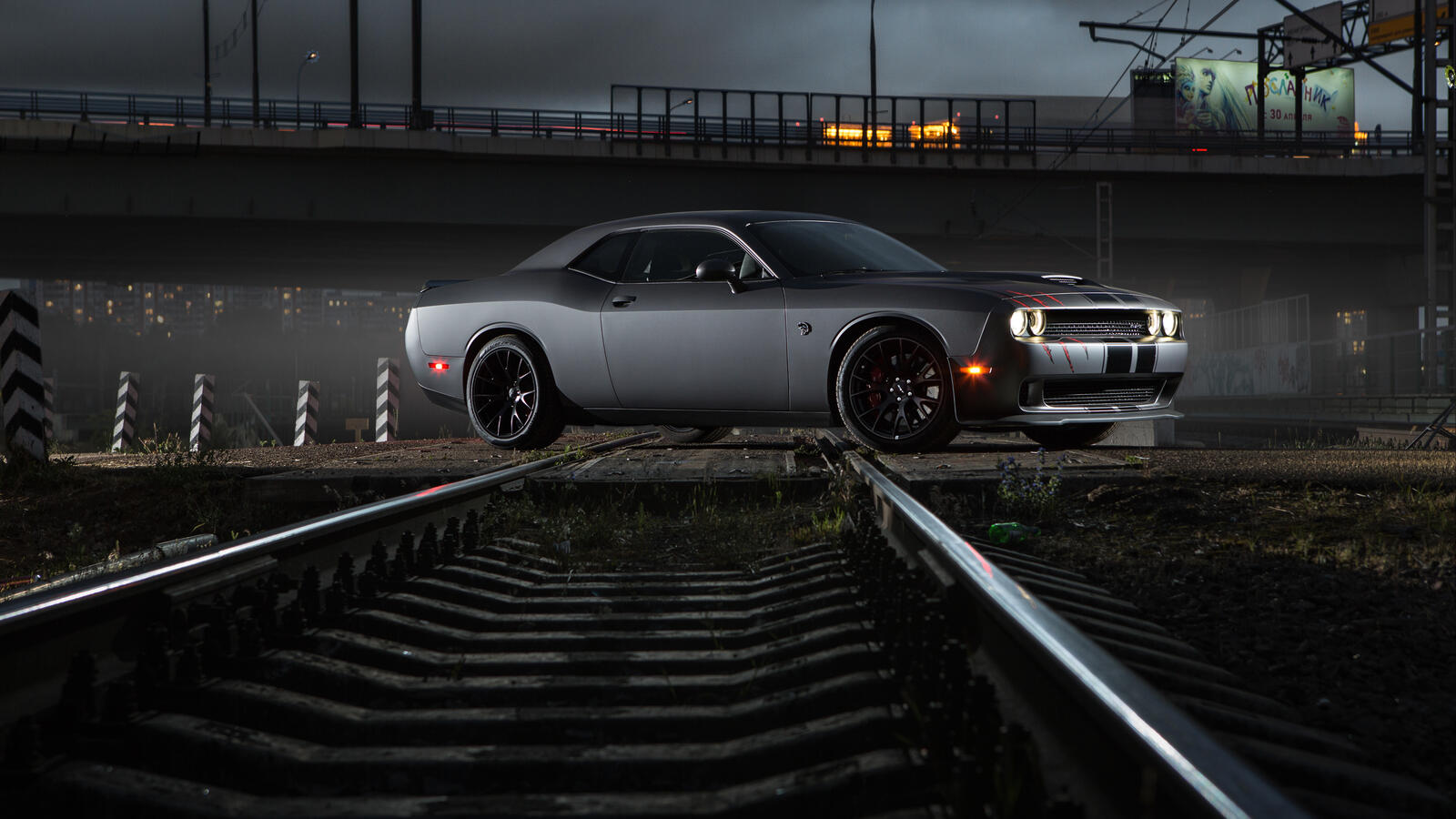 Free photo Dodge Challenger is parked on the railroad tracks