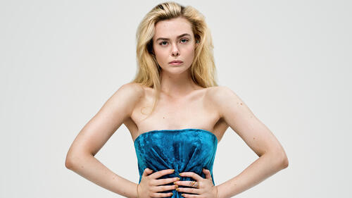 Elle Fanning in a blue dress with bare shoulders