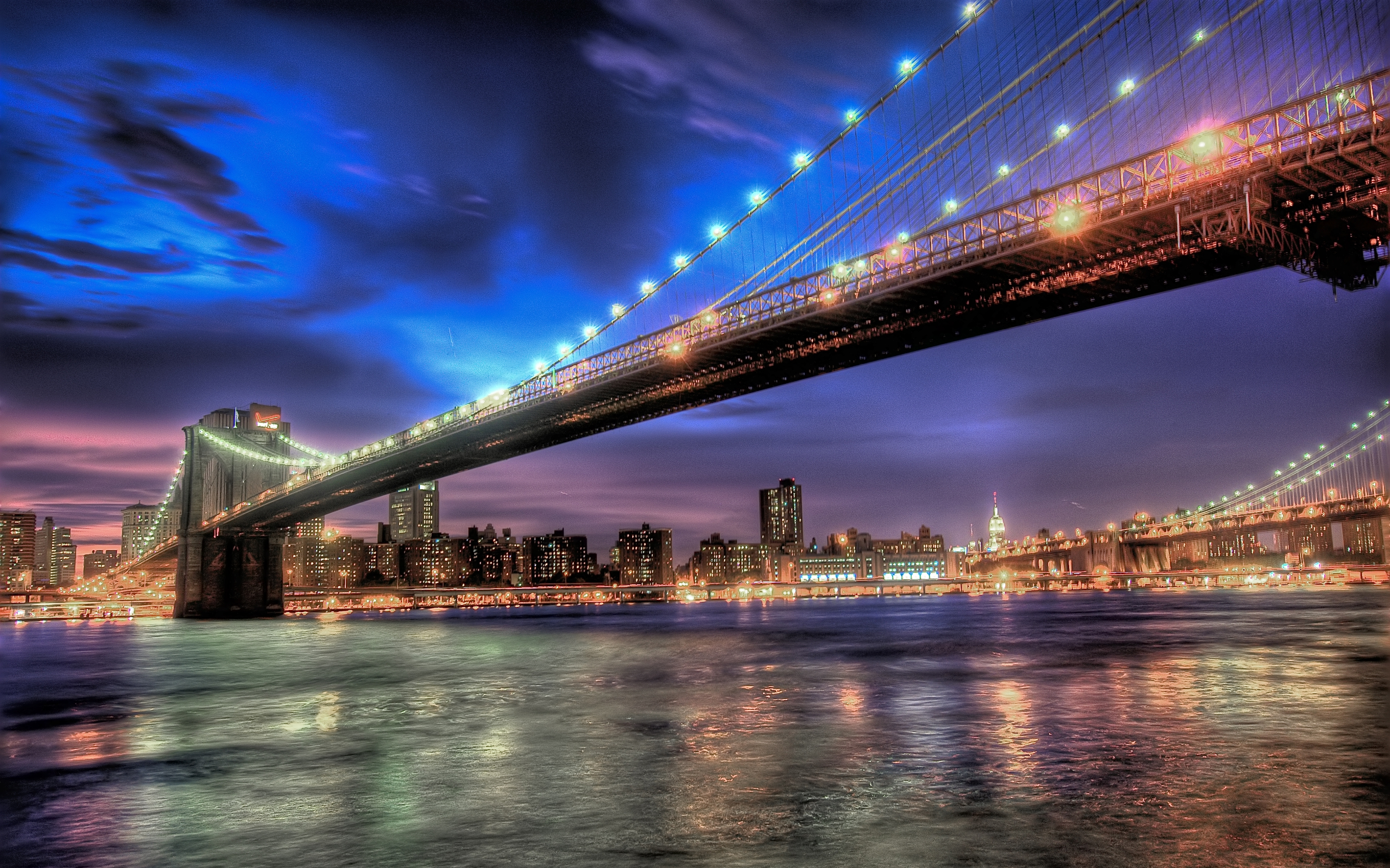 A nighttime bridge over the water in New York City
