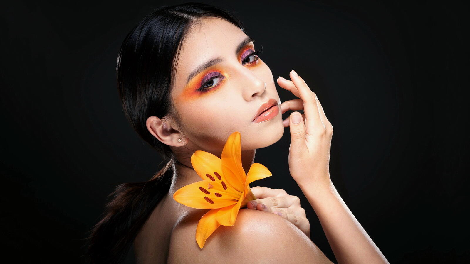Free photo Portrait of Catalina model with yellow flower on black background