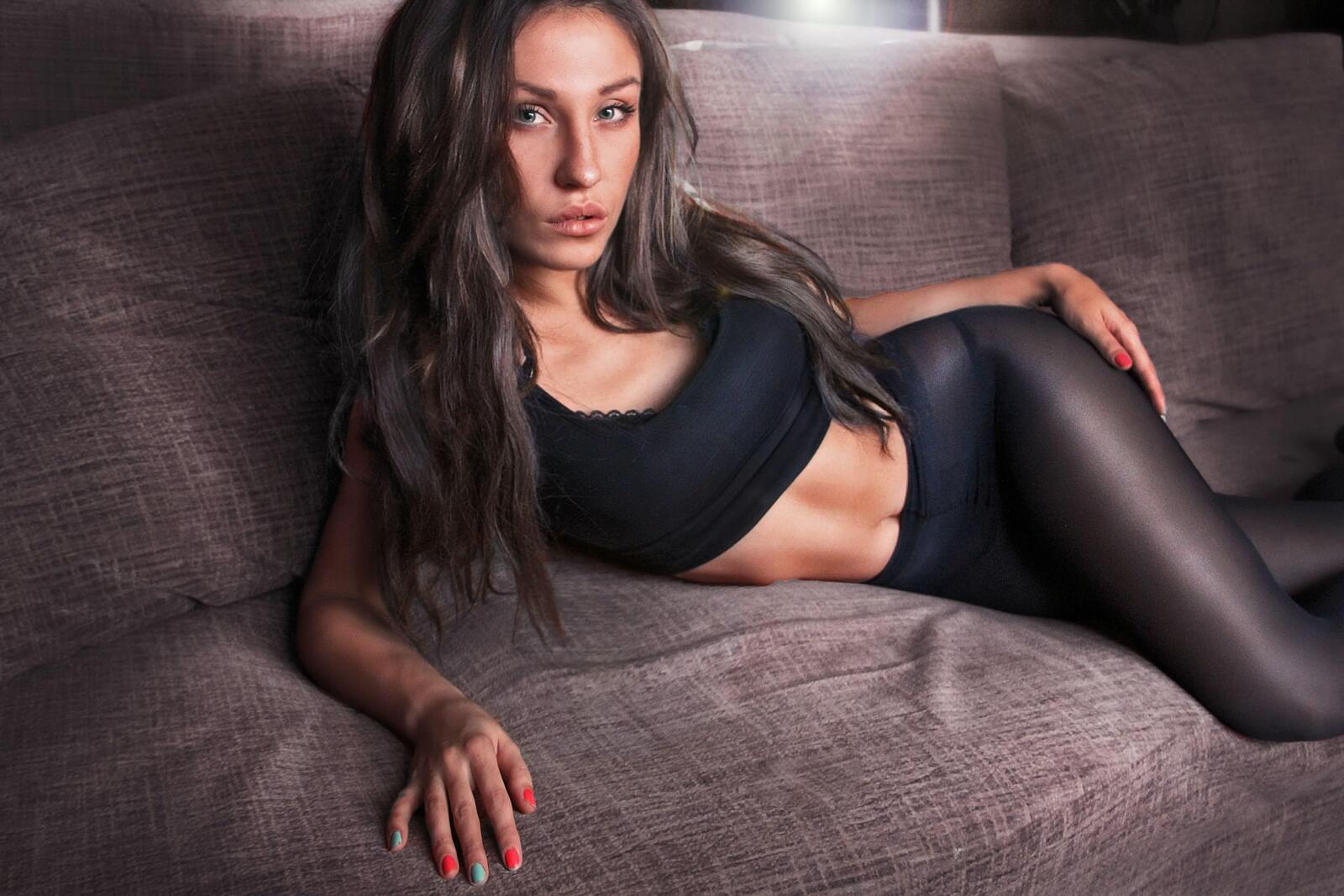 Free photo A girl with a beautiful figure lying on the couch