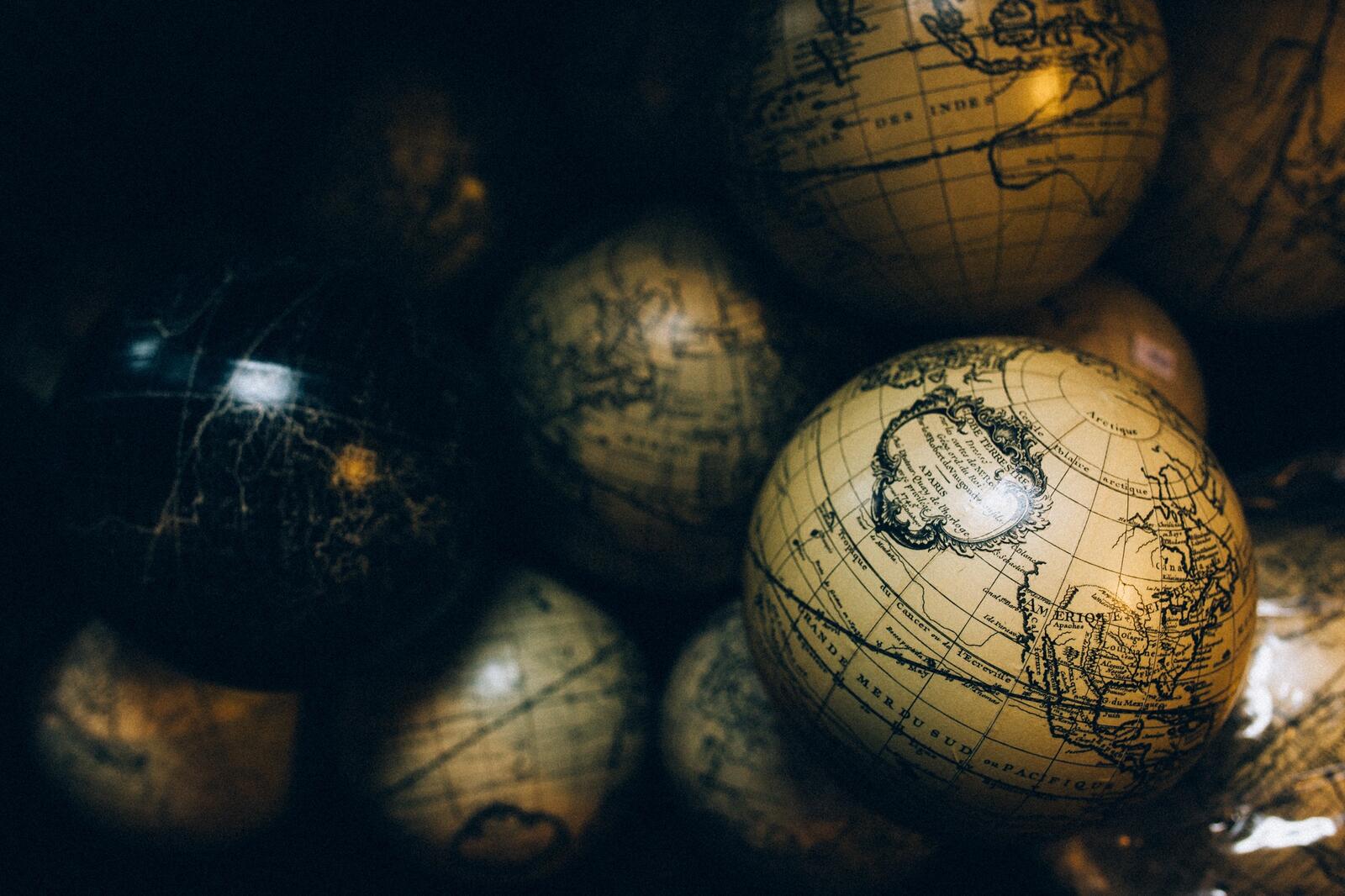 Free photo Balls keychain with antique world map