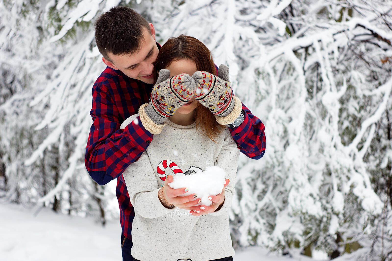Free photo A couple in love playing snowballs
