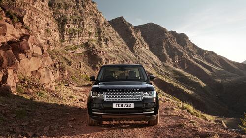 A black Range Rover driving over the cliffs