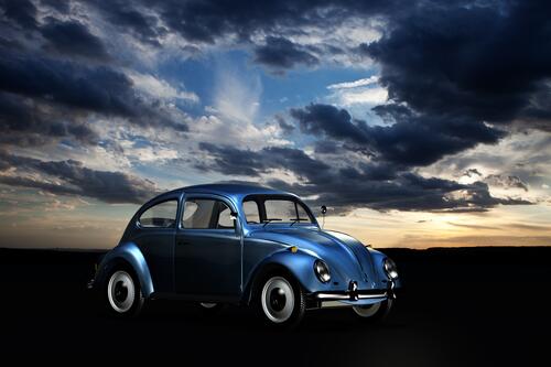 Blue Volkswagen Beetle at dusk.