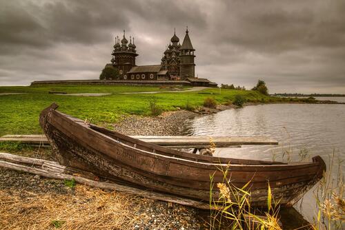 A wooden boat at a wooden church