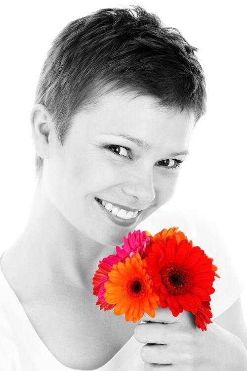 Monochrome portrait of a girl with red flowers