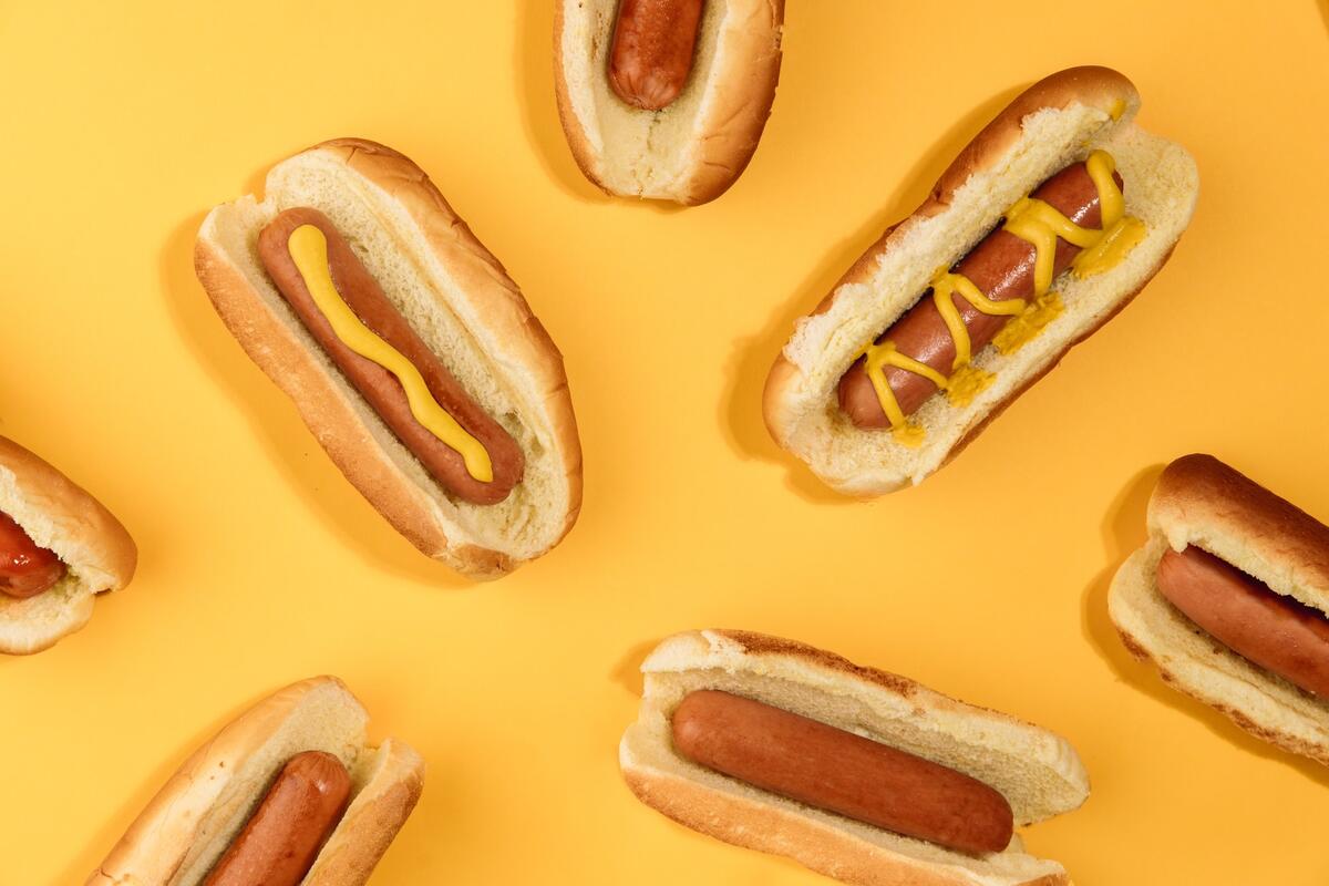 Wallpaper with hot dogs on a yellow background