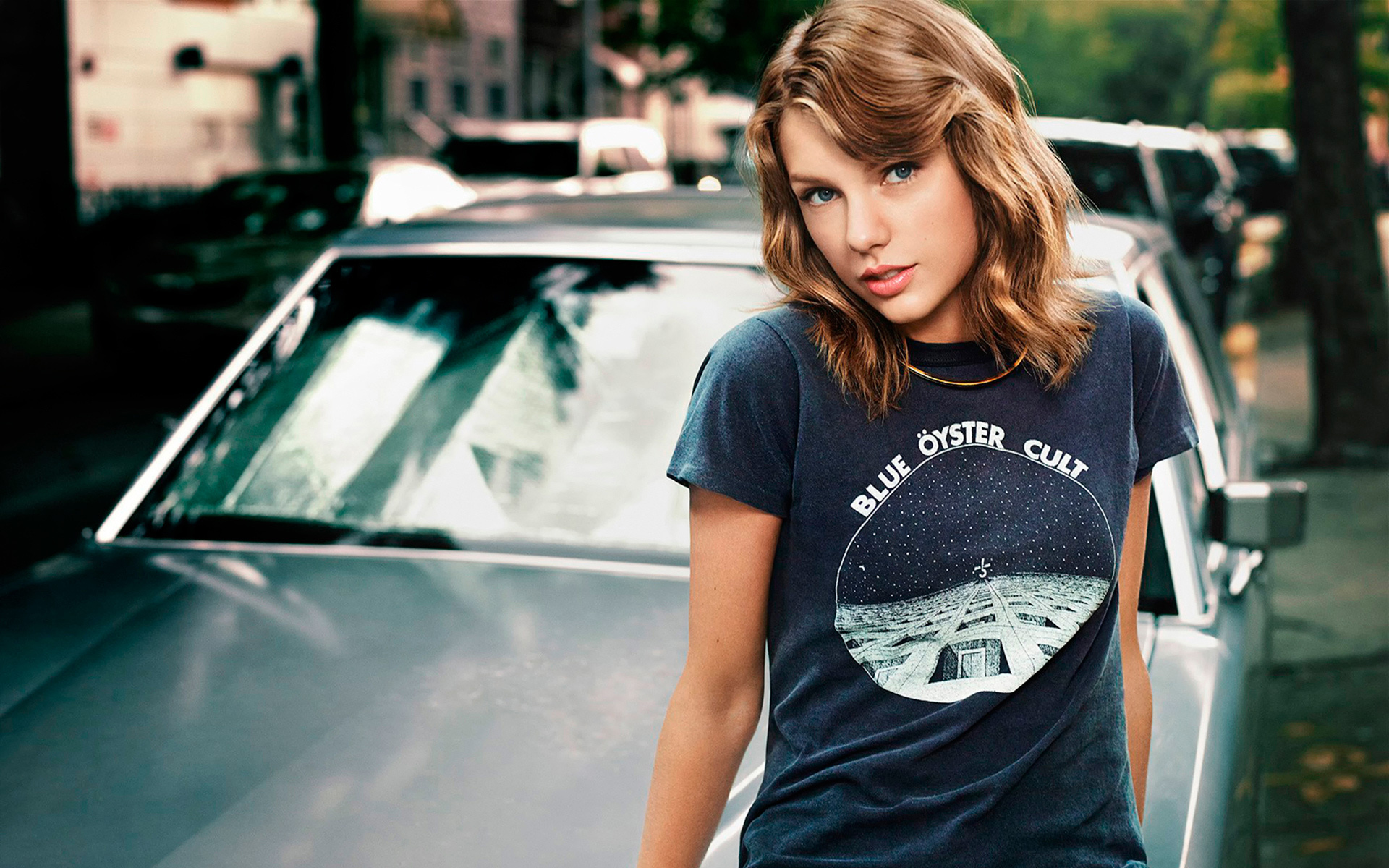 Taylor Swift in the background of a car
