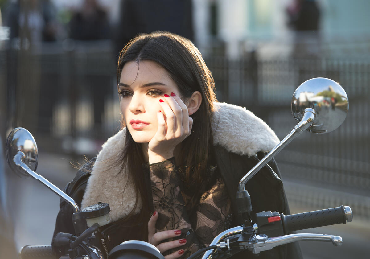 Kendall Jenner sits on a bike