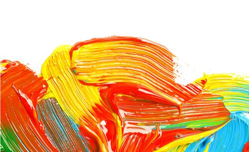 Colorful gouache strokes on a white sheet of paper