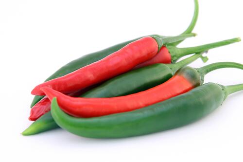 Red and green peppers on a white background