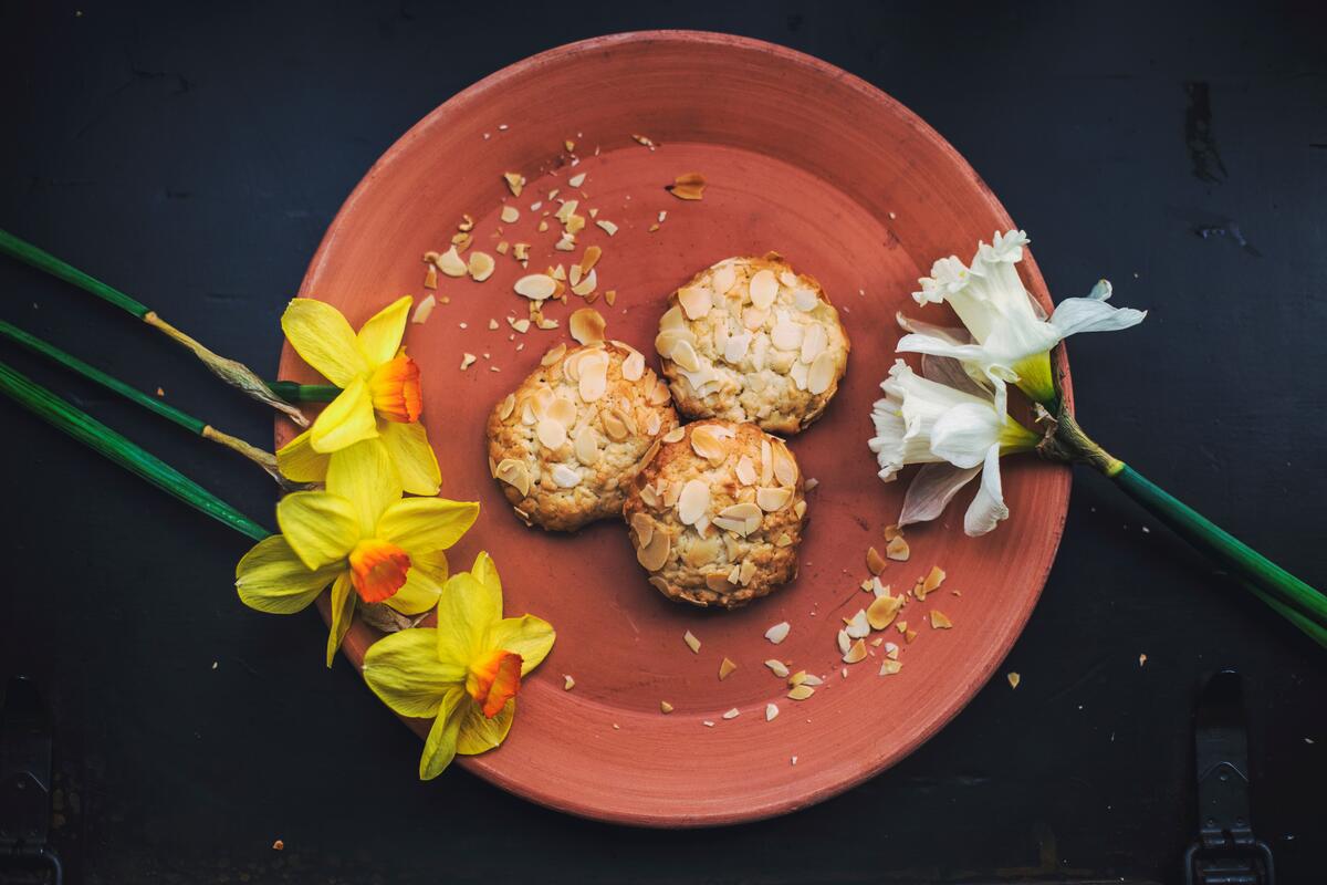 Delicious cookies on a plate with daffodil flowers