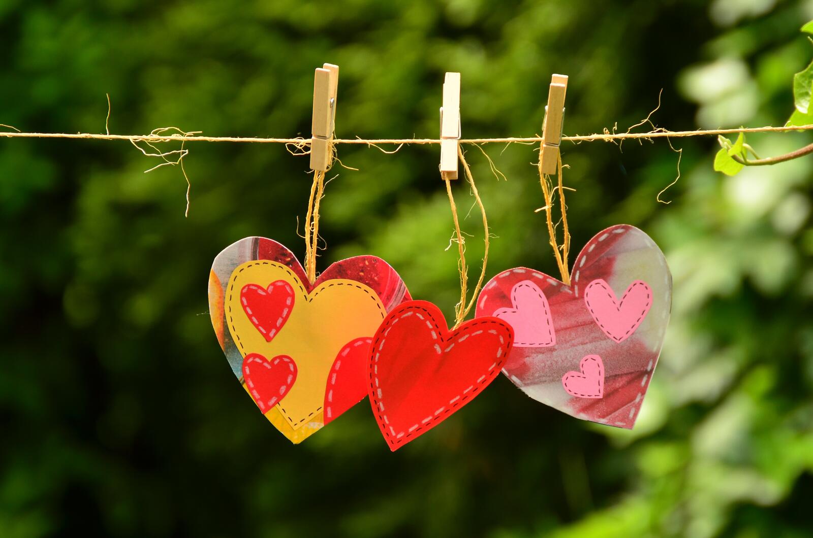 Free photo Valentine`s cards are hanging on a clothespin