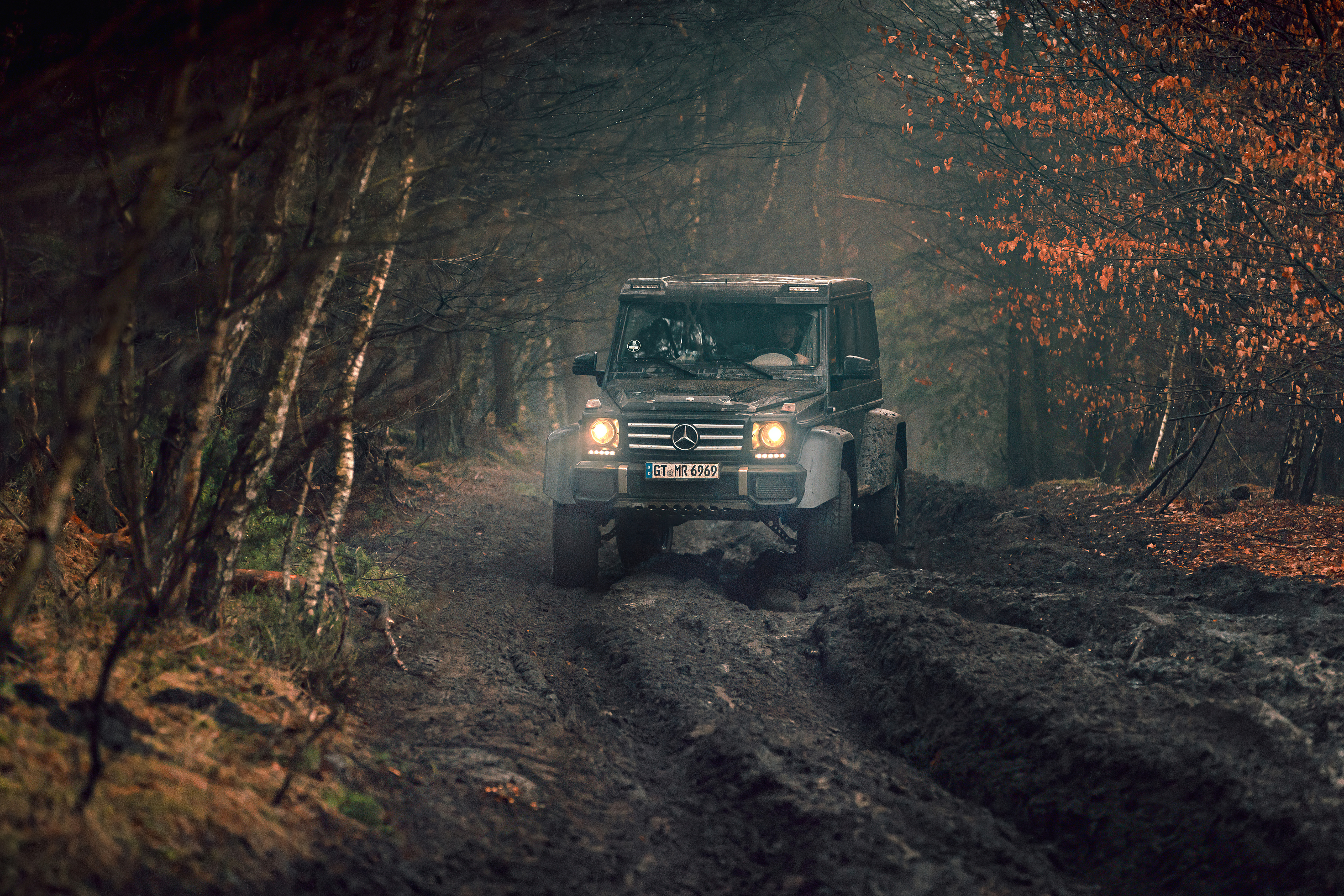 Black Mercedes G Class rides in the mud