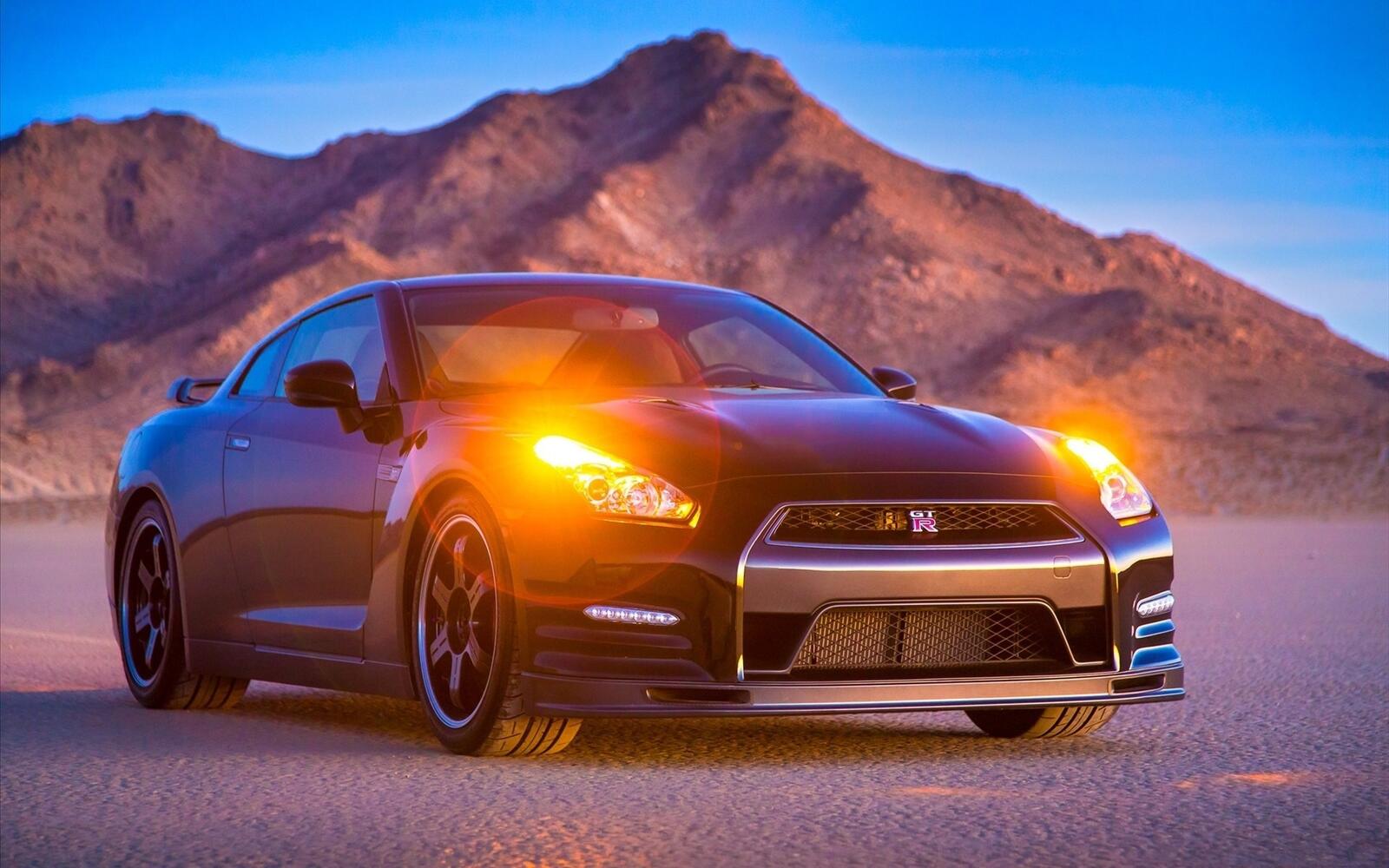 Free photo Black Nissan GTR with parking lights on