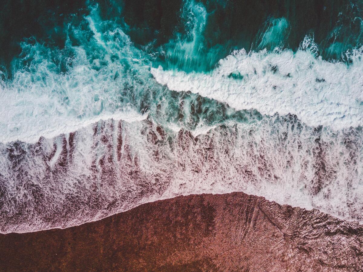 Waves crashing on the shoreline, a bird`s eye view