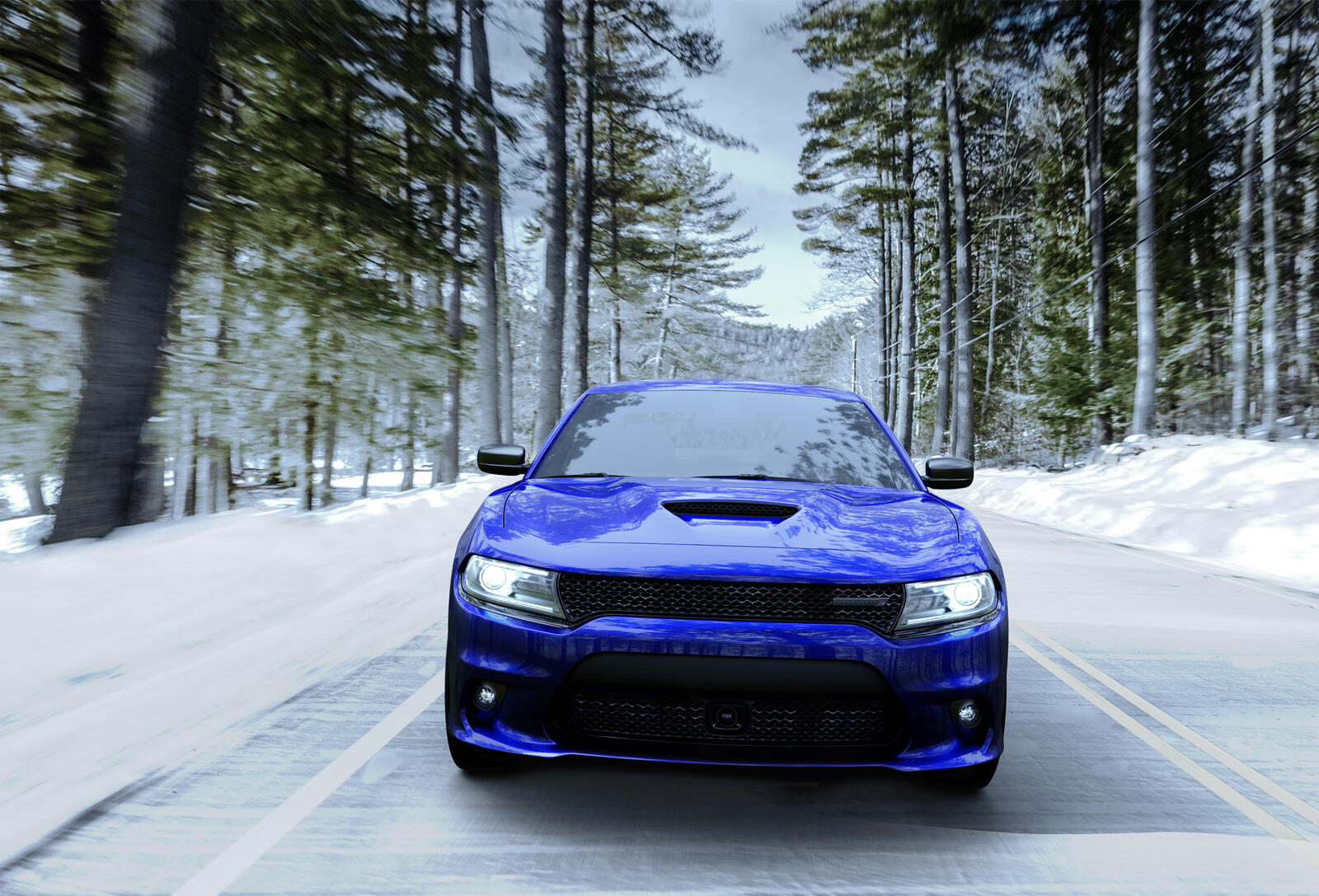 Free photo A blue Dodge Charger driving down a winter road.