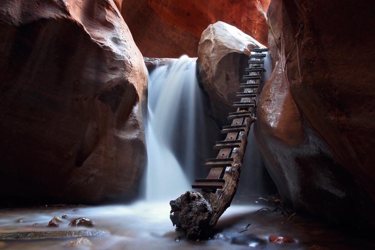 Waterfall in a cave with a makeshift ladder