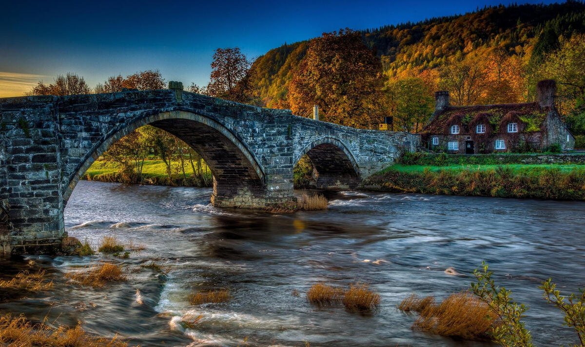 A stone bridge over a fast-flowing river