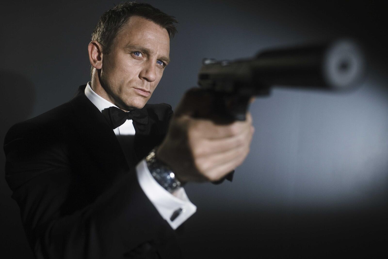 Free photo James Bond fires a silenced pistol.