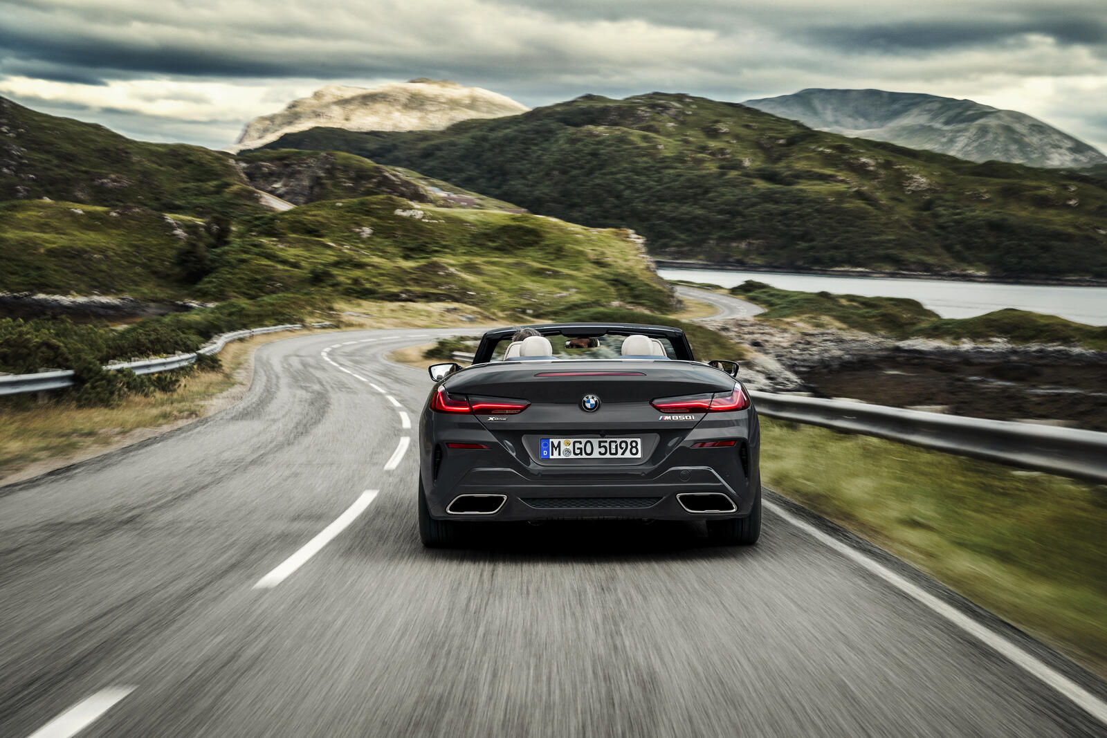 Free photo Black BMW M850i Convertible rushes down the highway