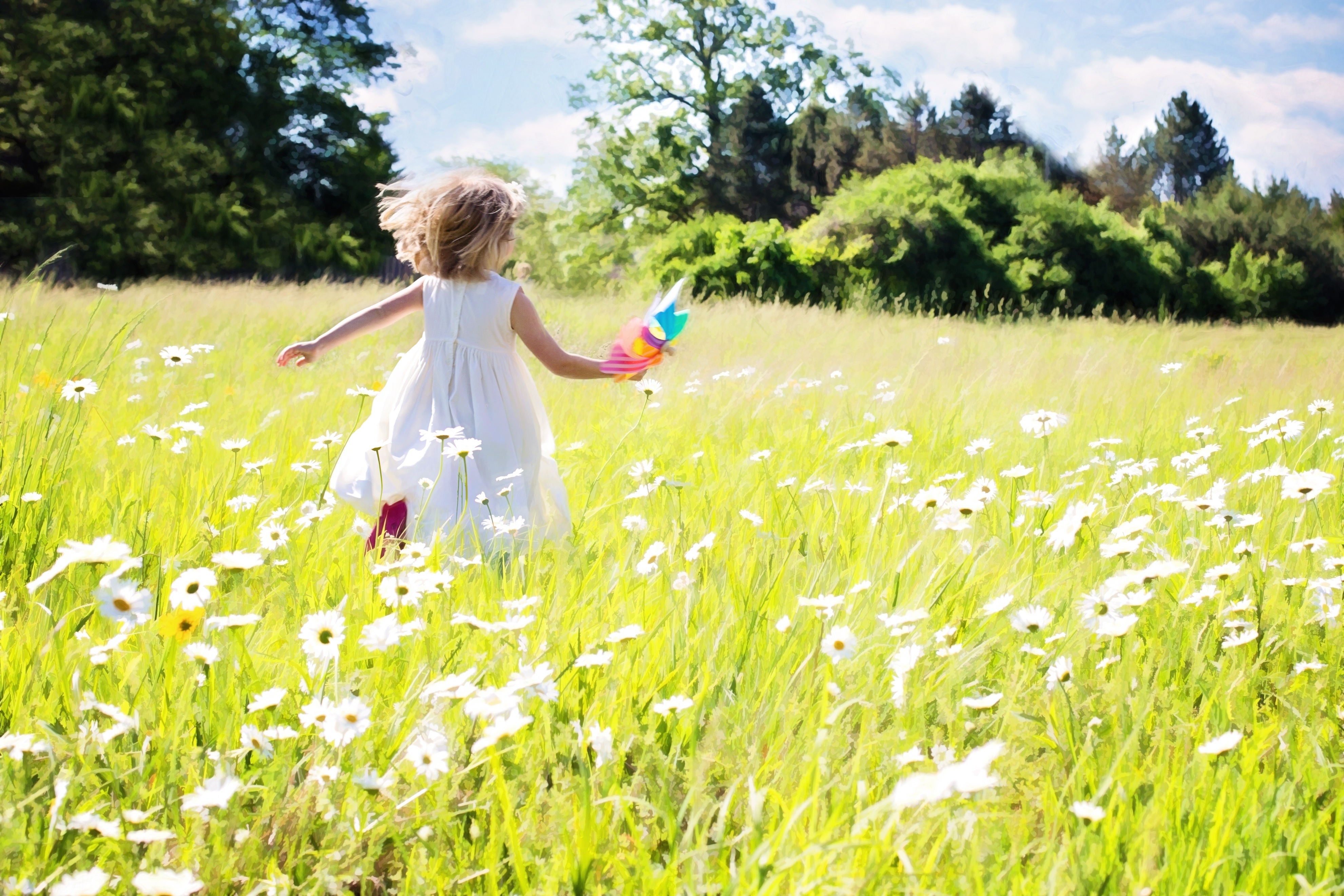 A joyful girl in a white dress running through a field of dandelions