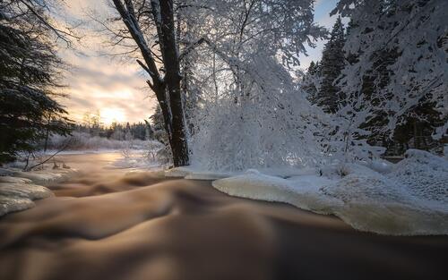 Течение реки со снежными берегами