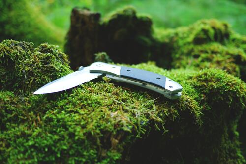 A mechanical knife on green moss