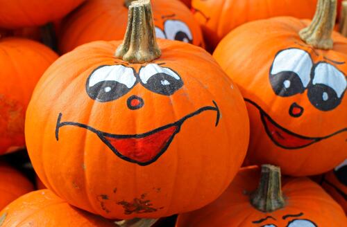 Drawing fun faces painted on pumpkins